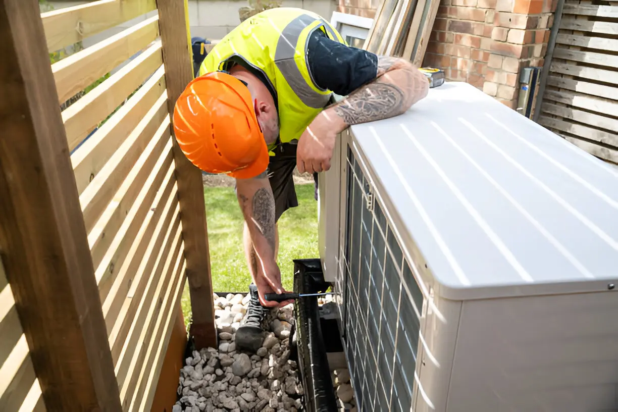 Home 11 Certified HVAC technician repairing a residential air conditioning unit in Orlando, Florida